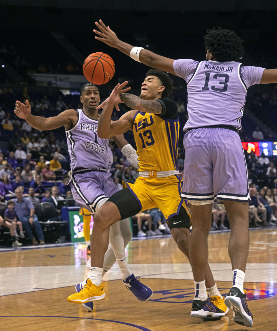 LSU forward Jalen Reed (13) loses the ball as Kansas State forward David N'Guessan (1) and Kansas State center Will McNair Jr. (13) defend during an NCAA college basketball game, Saturday, Dec. 9, 2023, at the LSU PMAC in Baton Rouge, La. (Hilary Scheinuk/The Advocate via AP)