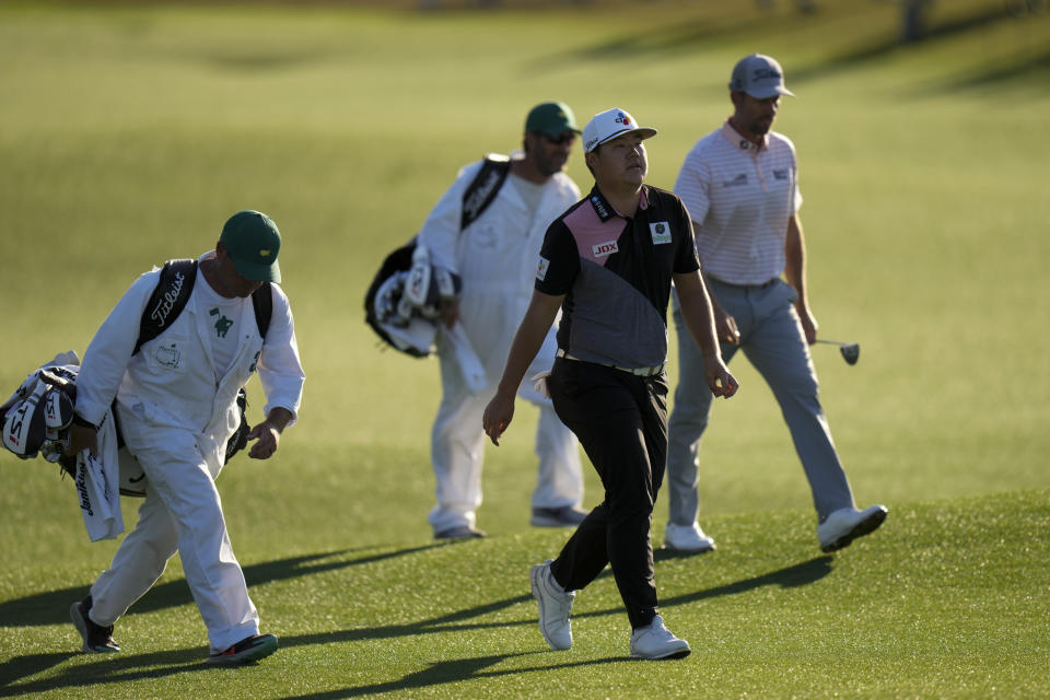 Sungjae Im, of South Korea, walks up the 18th hole with Webb Simpson, right, during the first round at the Masters golf tournament on Thursday, April 7, 2022, in Augusta, Ga. (AP Photo/Jae C. Hong)