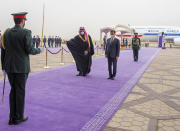 In this photo released by the Saudi Royal Palace, Saudi Crown Prince Mohammed bin Salman, right, and South Korean President Moon Jae-in, greet an honor guard at Riyadh International Airport, Saudi Arabia, Tuesday, Jan. 18, 2022. It is the latest visit by a head of state to Saudi Arabia as a growing number of world leaders resume bilateral meetings and trips abroad following COVID-19 vaccine rollouts in many parts of the world. (Bandar Aljaloud/Saudi Royal Palace via AP)