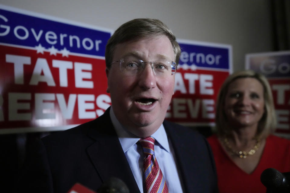 With wife Elee Reeves at his side, Republican Mississippi Gov. Tate Reeves addresses reporters in Jackson, Miss., after winning the party primary Tuesday, Aug. 8, 2023. Reeves defeated two challengers for the party nomination. (AP Photo/Rogelio V. Solis)