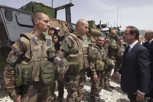 French President Francois Hollande reviews troops, on May 25, during a visit to a military base in Kapisa, in Afghanistan, where most French troops are stationed in Afghanistan. Hollande said on Friday that France would coordinate with NATO allies the withdrawal of its combat troops from Afghanistan