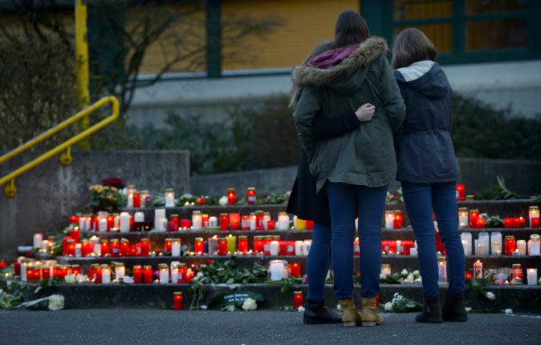 Students gather at a memorial of flowers and candles in front of the Joseph Koenig Gymnasium secondary school in Haltern am See, Germany, on March 24, 2015