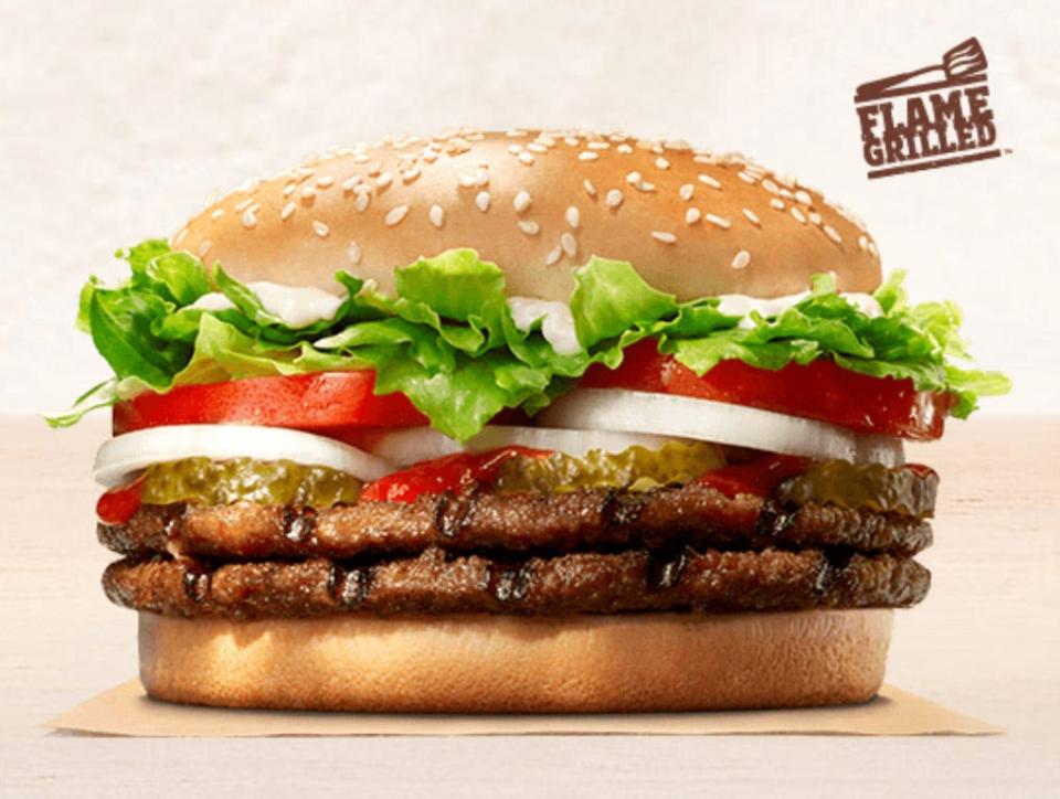 DOUBLE WHOPPER® Sandwich is a pairing of two ¼ lb* savory flame-grilled beef patties topped with juicy tomatoes, fresh lettuce, creamy mayonnaise, ketchup, crunchy pickles, and sliced white onions on a soft sesame seed bun. Photo Burger King