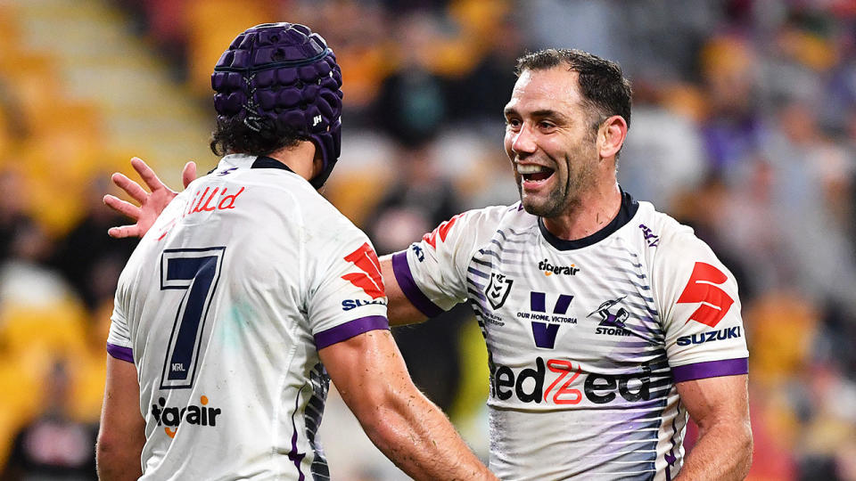 Pictured here, Melbourne Storm legend Cameron Smith celebrates with Jahrome Hughes.