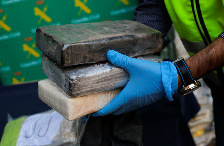 Police display a portion of the more than six tonnes of cocaine hidden among bunches of bananas which officials siezed at an industrial estate at the police headquarters in Malaga, Spain, October 25, 2018. REUTERS/Jon Nazca