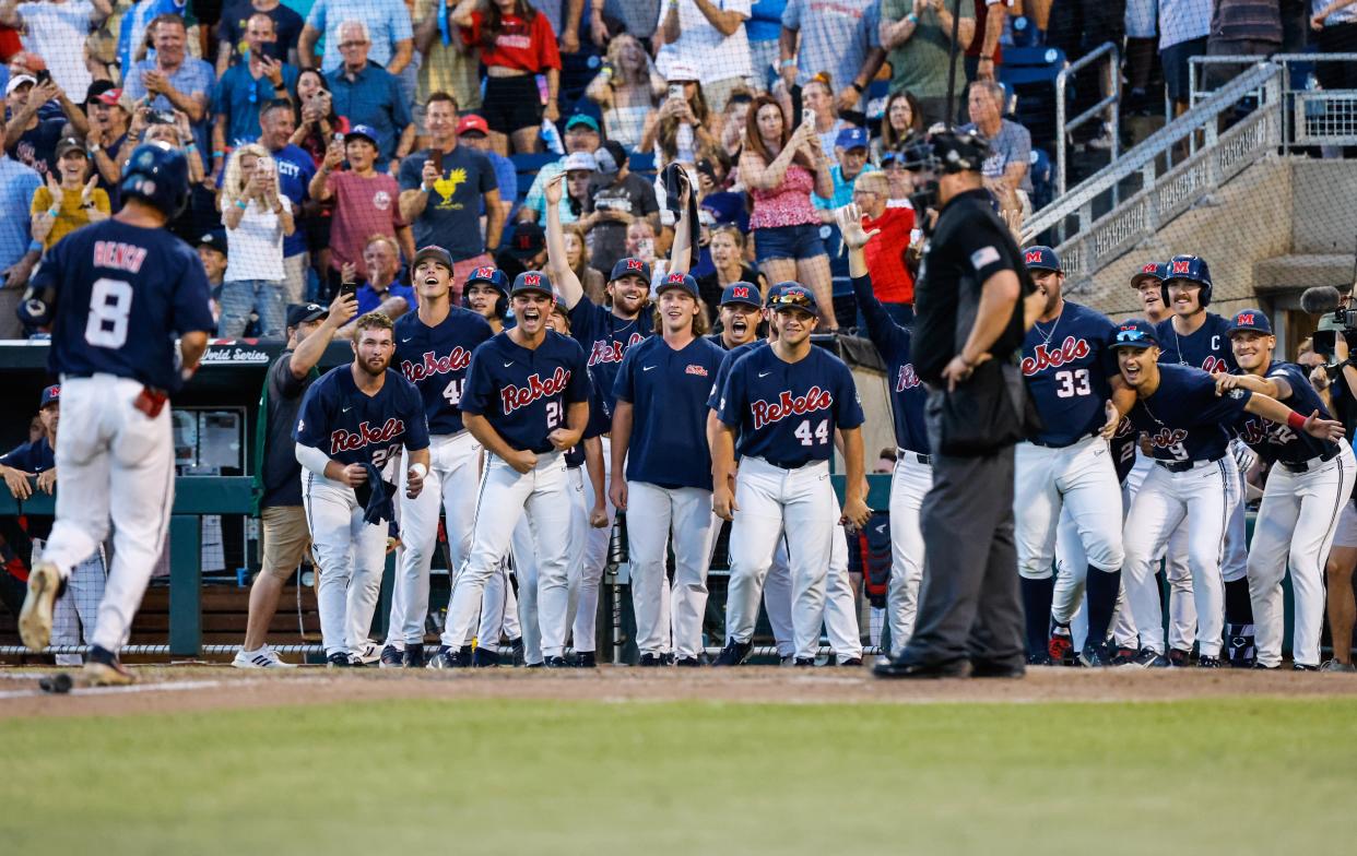 Jun 25, 2022; Omaha, NE, USA;  Ole Miss dugout reacts to a home run by utility Justin Bench (8) during the eighth inning at Charles Schwab Field. Mandatory Credit: Jaylynn Nash-USA TODAY Sports
