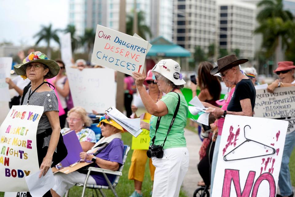 The Democratic Women's Club of Palm Beach County and the Palm Beach County National Organization for Women hold a "Bigger Than Roe" rally on the sidewalk along Palm Beach Lakes Boulevard in January.