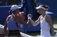 Liudmila Samsonova, right, of Russia, shakes hands with Xiyu Wang, left, of China, during a match at the Citi Open tennis tournament Saturday, Aug. 6, 2022, in Washington. (AP Photo/Nick Wass)