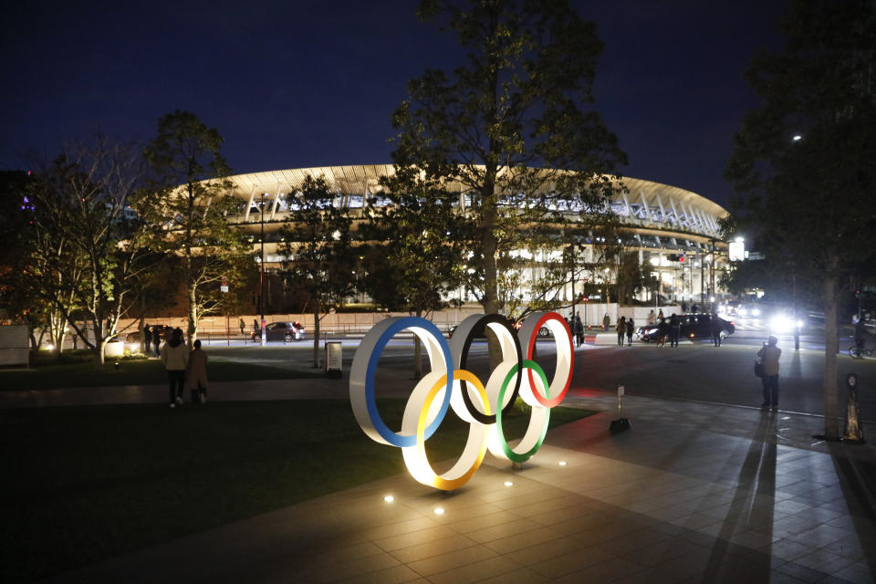 The Olympic rings stand near the new National Stadium Sunday, Dec. 15, 2019, in Tokyo. The stadium is officially completed. (AP Photo/Jae C. Hong)