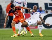 Olympique Marseille's Andre Ayew (R) challenges Lorient's Yann Jouffre during their French Ligue 1 soccer match at the Velodrome stadium in Marseille, France, April 24, 2015. REUTERS/Jean-Paul Pelissier