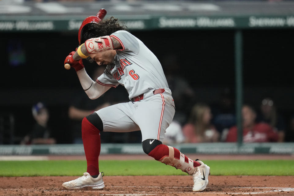 Cincinnati Reds' Jonathan India falls after being hit with a pitch in the fifth inning of a baseball game against the Cleveland Guardians in Cleveland, Tuesday, Sept. 24, 2024. (AP Photo/Sue Ogrocki)