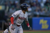 Boston Red Sox's Enmanuel Valdez watches as Oakland Athletics center fielder JJ Bleday commits a fielding error during the second inning of a baseball game Monday, April 1, 2024, in Oakland, Calif. Valdez reached second on the play. (AP Photo/Godofredo A. Vásquez)