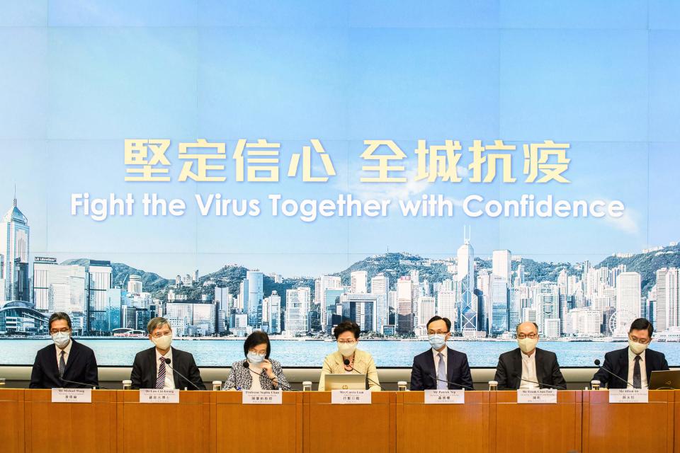 (L-R) Secretary for Development Michael Wong, Secretary for Labour and Welfare Law Chi-kwong, Secretary for Food and Health Sophie Chan, Hong Kong Chief Executive Carrie Lam, Secretary for the Civil Service Patrick Nip, Secretary for Transport and Housing Frank Chan Fan and Secretary for Innovation and Technology Alfred Sit hold a press conference at the government headquarters in Hong Kong on August 21, 2020, to provide details of the citywide COVID-19 testing initiative, due to start on September 1. (Photo by Anthony WALLACE / AFP) (Photo by ANTHONY WALLACE/AFP via Getty Images)