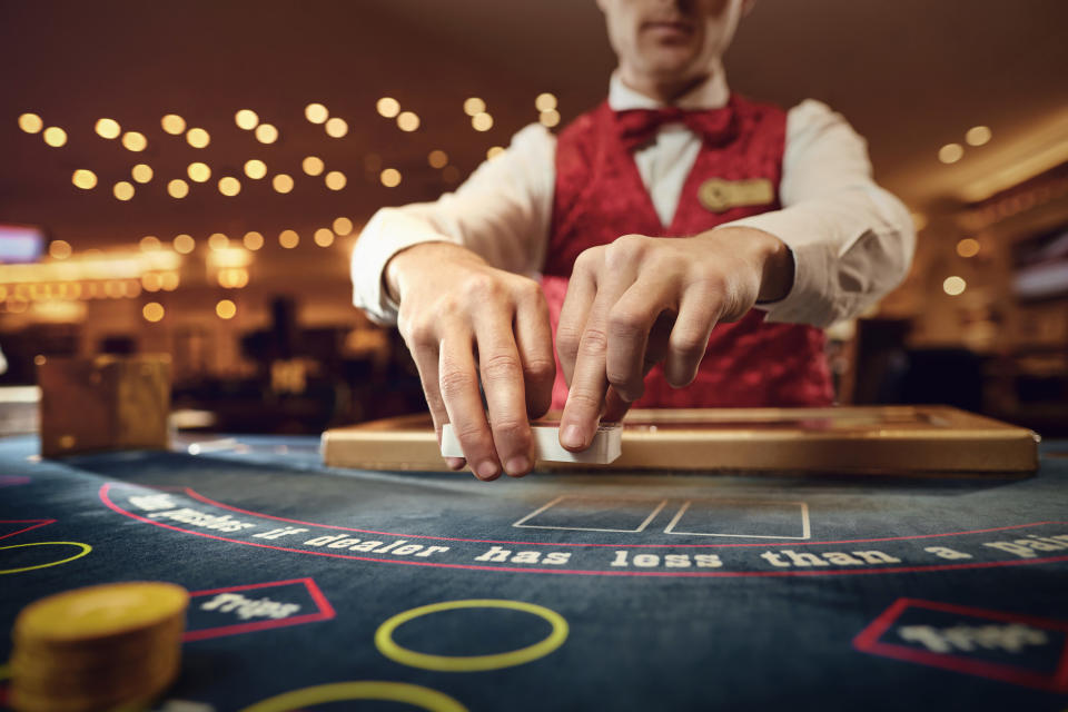 dealer holding cards in a casino