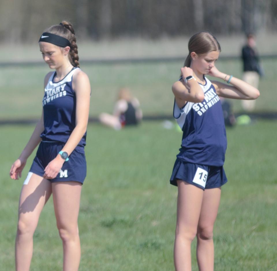 Miriam Murrell (left) and Sophia Harding (right) prepare for a race during the Johannesburg-Lewiston Invite on Tuesday, May 9.