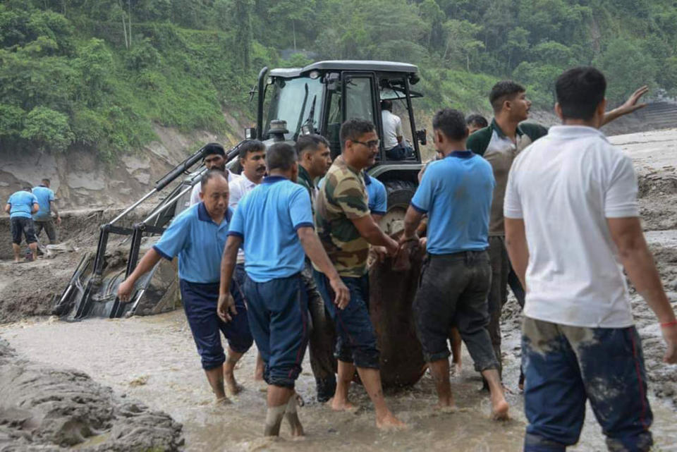 Rescue work continues after flash floods triggered by a sudden heavy rainfall swamped the Rangpo town in Sikkim, India, Thursday, Oct.5. 2023. The flooding took place along the Teesta River in the Lachen Valley of the north-eastern state, and was worsened when parts of a dam were washed away. (AP Photo/Prakash Adhikari)