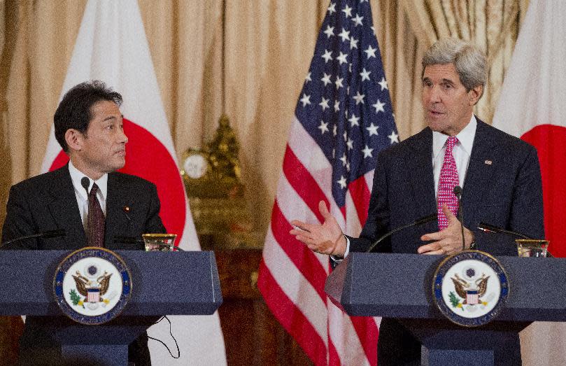 Japanese Foreign Minister Fumio Kishida listens as Secretary of State John Kerry speaks after a meeting at the State Department in Washington, Friday, Feb. 7, 2014. (AP Photo/ Evan Vucci)