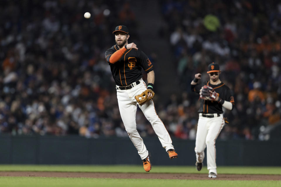 San Francisco Giants third baseman Evan Longoria throws to first base for the out on Los Angeles Dodgers' Mookie Betts during the eighth inning of a baseball game in San Francisco, Saturday, Sept. 4, 2021. (AP Photo/John Hefti)