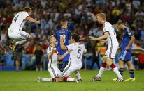 Germany players celebrate after winning the 2014 World Cup final between Germany and Argentina at the Maracana stadium in Rio de Janeiro July 13, 2014. REUTERS/Darren Staples (BRAZIL - Tags: TPX IMAGES OF THE DAY SOCCER SPORT WORLD CUP)