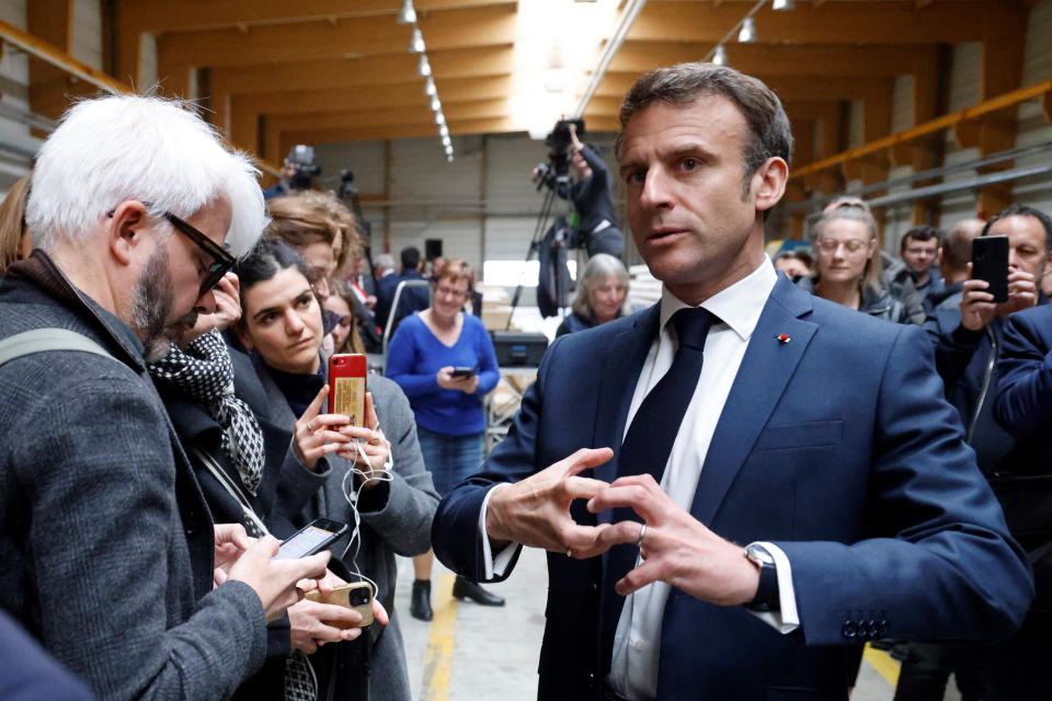 French President Emmanuel Macron speaks to journalists during a visit to Mathis, a company specialized in large wooden buildings, in Muttersholtz, eastern France, Wednesday, April 19, 2023. (Ludovic Marin, Pool via AP)