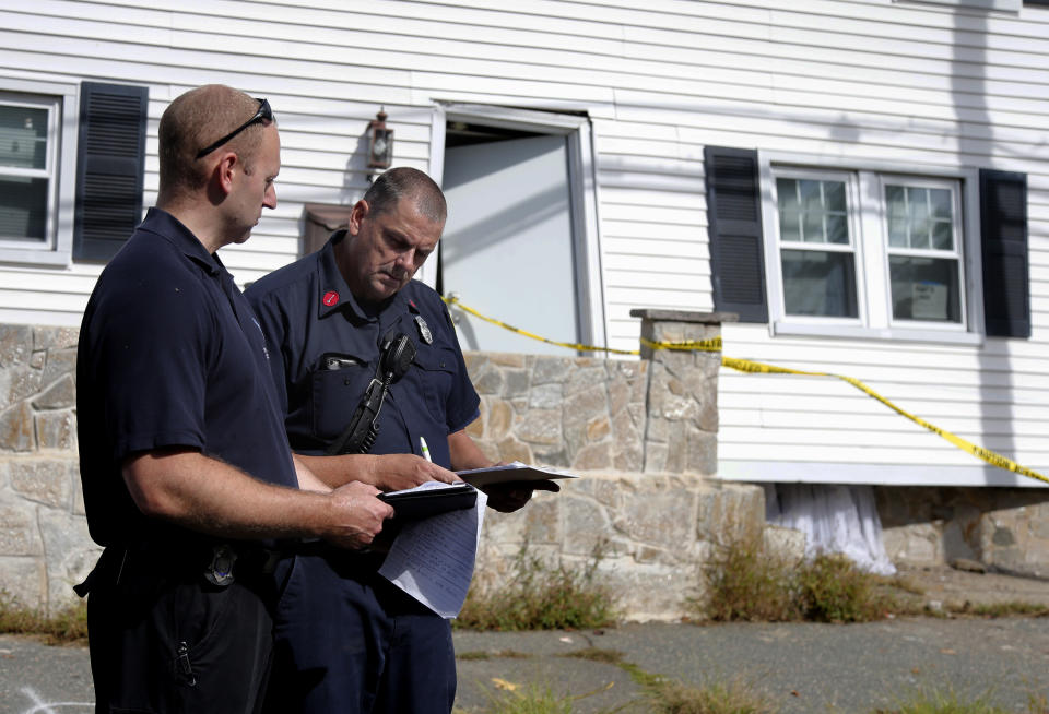 Fire inspectors take notes outside a house that was blown off its foundation on Kingston Street in Lawrence, Mass., Friday, Sept. 14, 2018. Multiple houses were damaged Thursday afternoon from gas explosions and fires triggered by a problem with a gas line that feeds homes in several communities north of Boston. (AP Photo/Mary Schwalm)