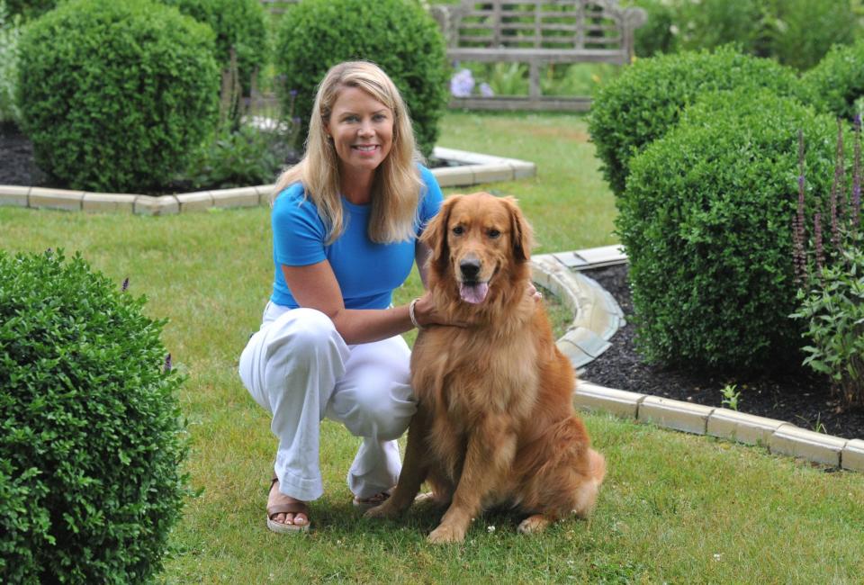 Heather Cyr, of Scituate, and her therapy dog, Tripp, a golden retriever, bring comfort to patients of the NVNA and Hospice. They are in the gardens at the Pat Roche Hospice Home in Hingham.