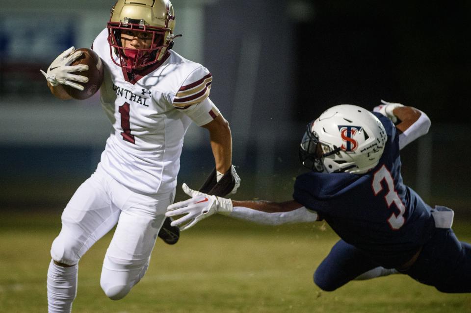 Harnett Central’s Ethyn Muhammad outruns the grasp of Terry Sanford’s Christian Carter during the first quarter on Friday, Oct. 6, 2023, at Terry Sanford High School.