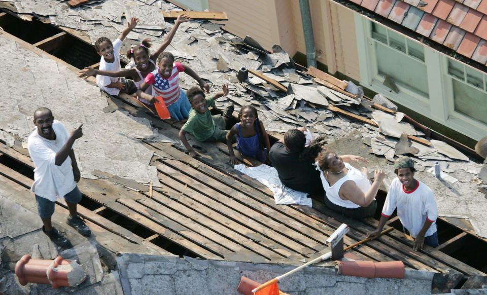 New Orleans residents wait to be rescued from the floodwaters of Hurricane Katrina Wednesday, Aug. 31, 2005 in New Orleans. After Sept. 11, the TV event with the most impact was the coverage of Hurricane Katrina in 2005. (AP Photo/David J. Phillip)