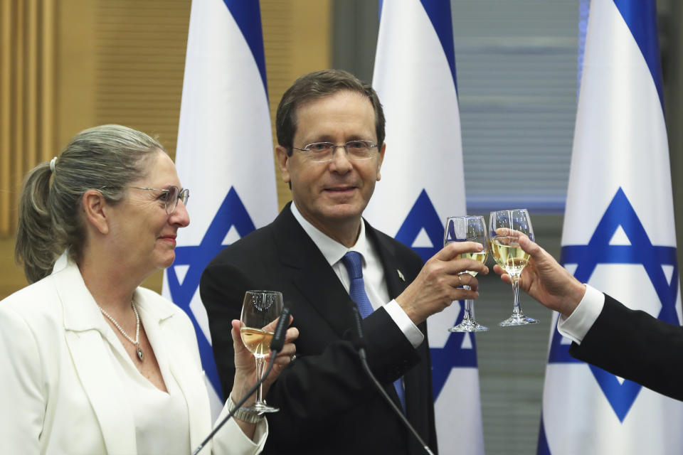 President-elect Isaac Herzog and his wife Michal celebrate after a special session of the Knesset whereby Israeli lawmakers elected the new president, at the Knesset, Israel's parliament, in Jerusalem Wednesday, June 2, 2021. (Ronen Zvulun/Pool Photo via AP)