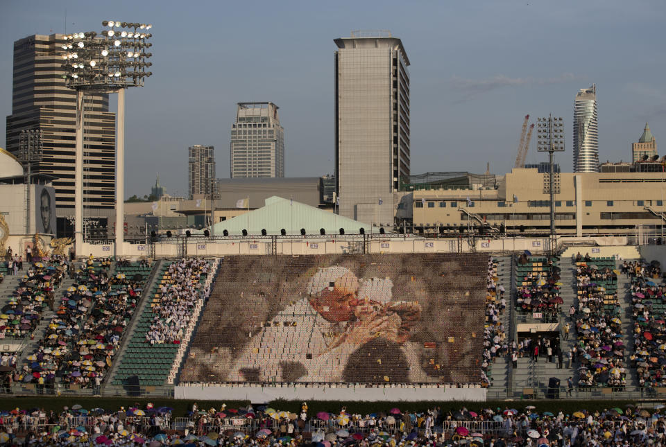 Students practice flipping boards with photos to reveal a full-mosaic portrait of Pope Francis before a Holy Mass at National Stadium in Bangkok, Thailand, Thursday, Nov. 21, 2019.(AP Photo/Sakchai Lalit)