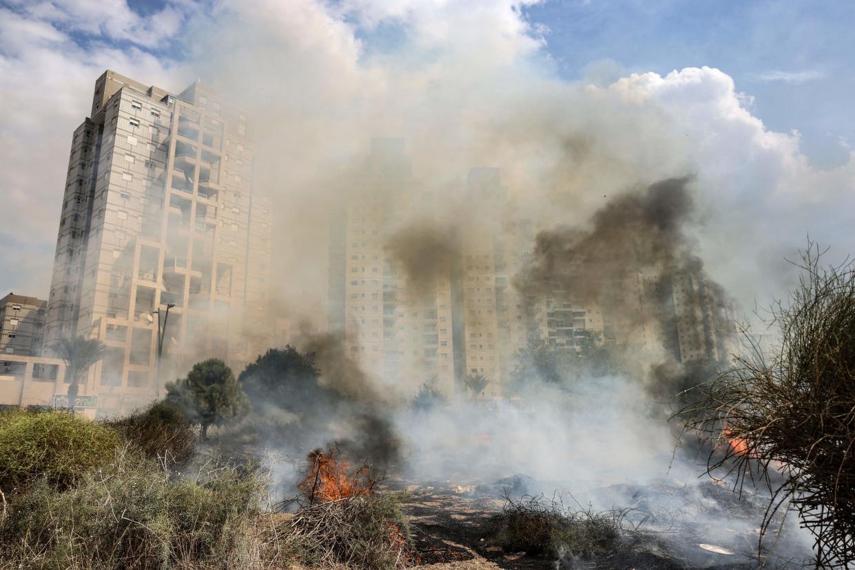 Smoke billows from a fire in front of a large building following a rocket attack in the southern Israeli city of Ashkelon.