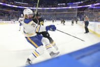 Boston Bruins center Brad Marchand (63) checks Buffalo Sabres defenseman Rasmus Dahlin (26) to the ice during the second period of an NHL hockey game Friday, Oct. 22, 2021, in Buffalo, N.Y. (AP Photo/Joshua Bessex)