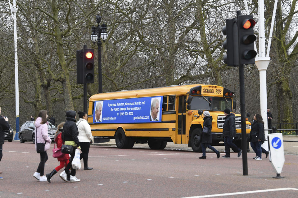 A yellow school bus with a message for the Britain's Prince Andrew, from US lawyer Gloria Allred, drives along The Mall towards Buckingham Palace in London Friday Feb. 21, 2020. Allred, who represents some of the accusers of Jeffrey Epstein, has been critical of the Prince Andrew for not speaking with the FBI about his former friend Epstein. Epstein died in a New York jail in August 2019 while he was awaiting trial on sex trafficking charges. U.S. authorities ruled the death a suicide. (Stefan Rousseau/PA via AP)