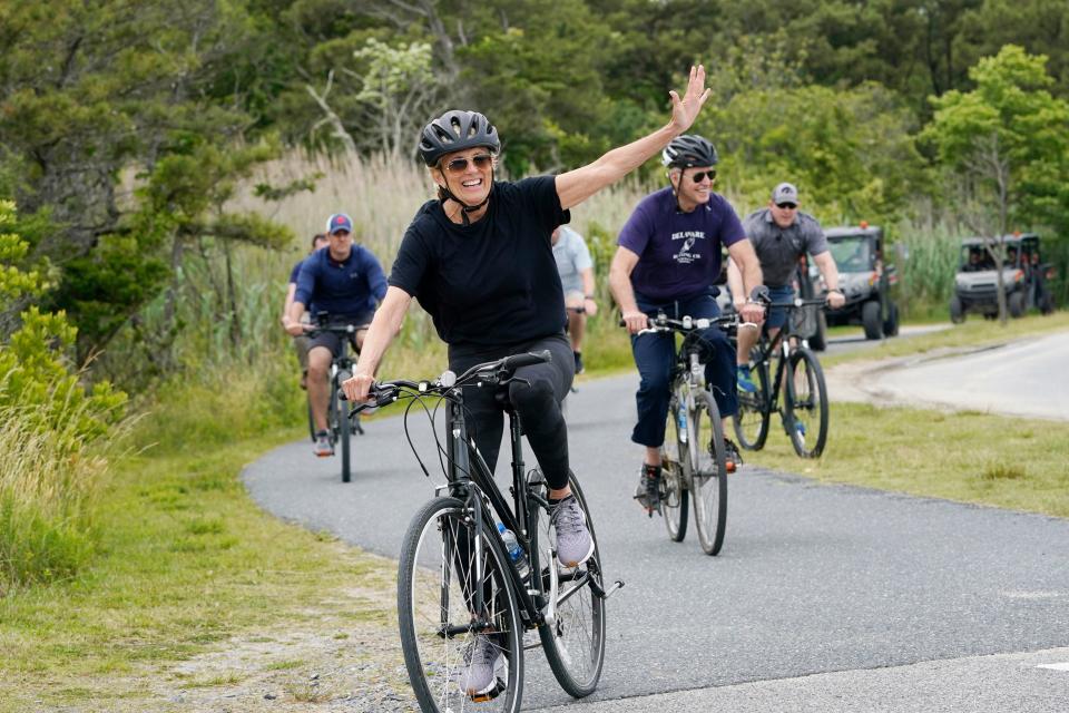 First lady Jill Biden waves as she rides her bike with President Joe Biden near Rehoboth Beach, Del., Thursday, June 3, 2021. The Bidens are spending a few days in Rehoboth Beach to celebrate first lady Jill Biden's 70th birthday.