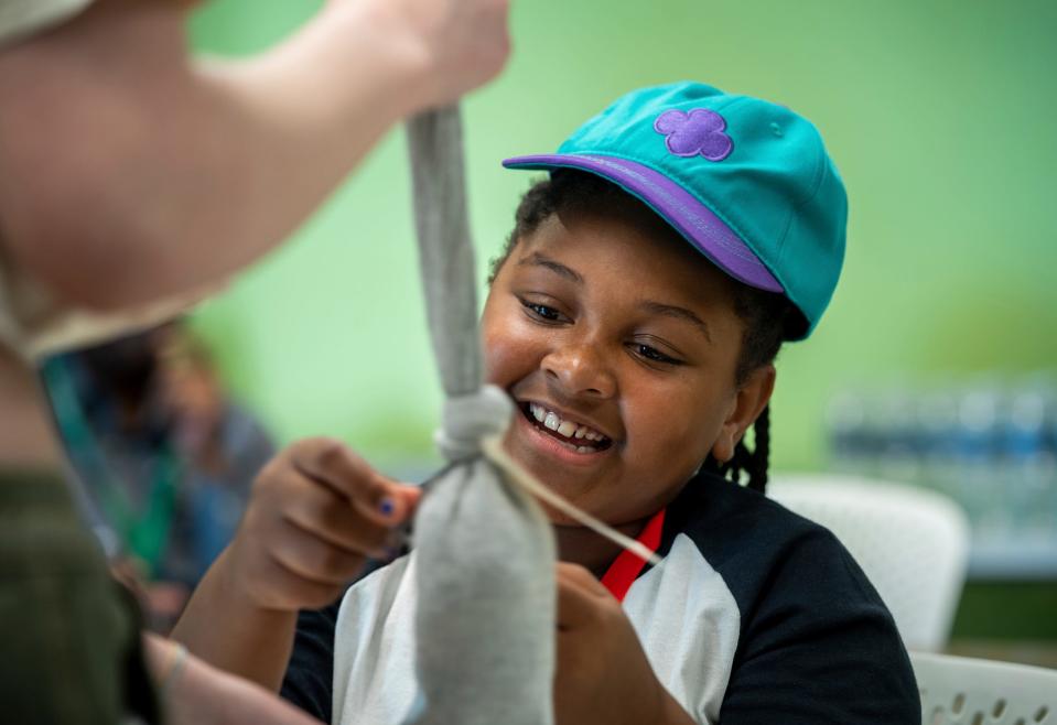 Iyannah Zinson, of Detroit, works to fill a sock while building a Caring Kids Kit providing needed supplies for homeless people that was started by Girl Scout Zoe Granger at the Girl Scouts of Southeastern Michigan's Detroit Service Center in Detroit on Wednesday, Aug. 16, 2023. Girl Scouts from Detroit and Downriver, who will be entering the fourth and fifth grades this coming school year, learned how to perform a Bronze Award Take Action Project, assembling kits of their own, which will later be donated to women's shelters in various communities where the Girl Scouts live.