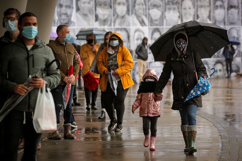 FILE PHOTO: Voters wait in line to cast their ballots in Brooklyn, New York