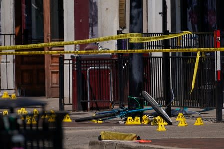 Evidence markers rest on the ground after a mass shooting in Dayton