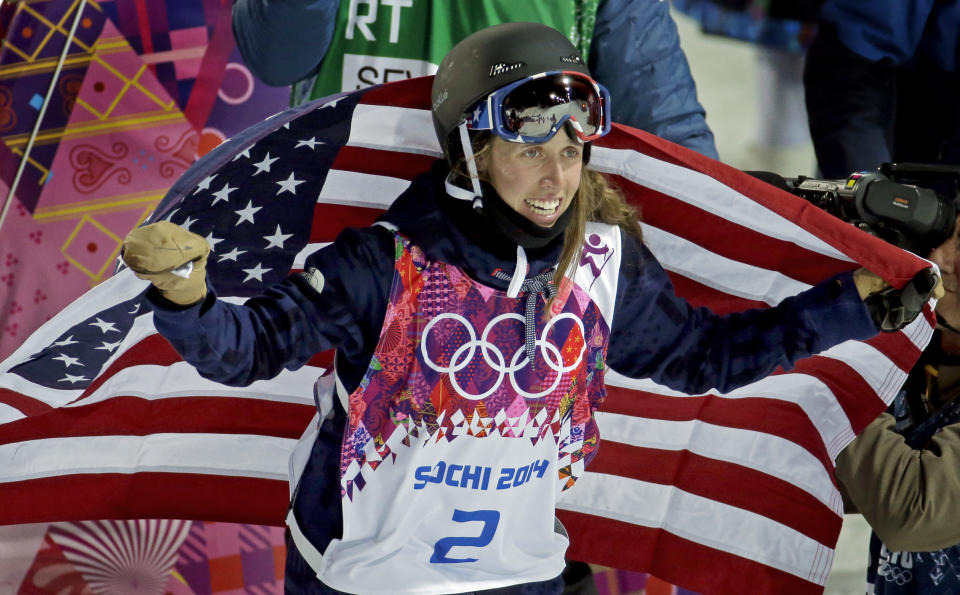 Maddie Bowman of the United States celebrates her gold medal in the women's ski halfpipe at the Rosa Khutor Extreme Park, at the 2014 Winter Olympics, Thursday, Feb. 20, 2014, in Krasnaya Polyana, Russia. (AP Photo/Charlie Riedel)