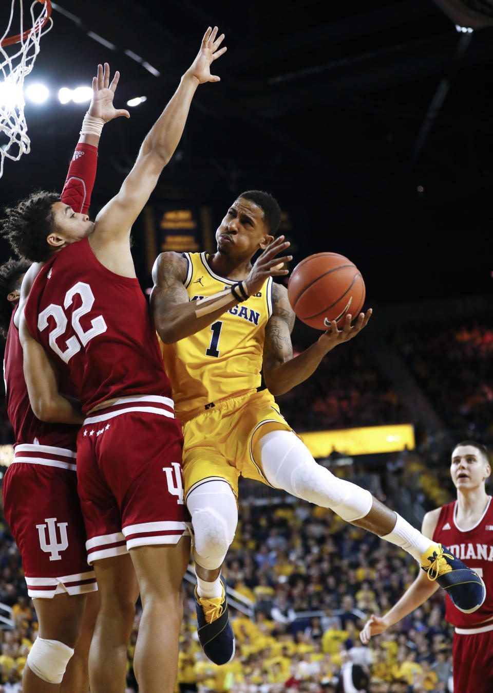 Michigan guard Charles Matthews (1) drives on Indiana forward Clifton Moore (22) in the second half of an NCAA college basketball game in Ann Arbor, Mich., Sunday, Jan. 6, 2019. (AP Photo/Paul Sancya)