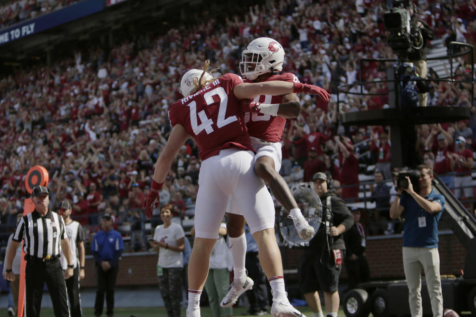 Washington State wide receiver De'Zhaun Stribling, right, celebrates his touchdown with teammate Billy Riviere III during the first half of an NCAA college football game against Colorado State, Saturday, Sept. 17, 2022, in Pullman, Wash. (AP Photo/Young Kwak)