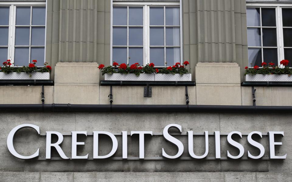 A sign hangs above the entrance to a Credit Suisse office building