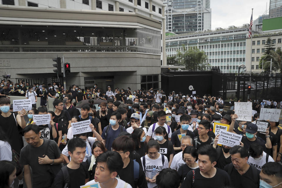 Protesters gather outside the U.S. Consulate as they stage a protest in Hong Kong, Wednesday, June 26, 2019. Hong Kong activists opposed to contentious extradition legislation on Wednesday called on leaders of the U.S., the European Union and others to raise the issue with Chinese President Xi Jinping at this week's G-20 summit in Japan. (AP Photo/Kin Cheung)