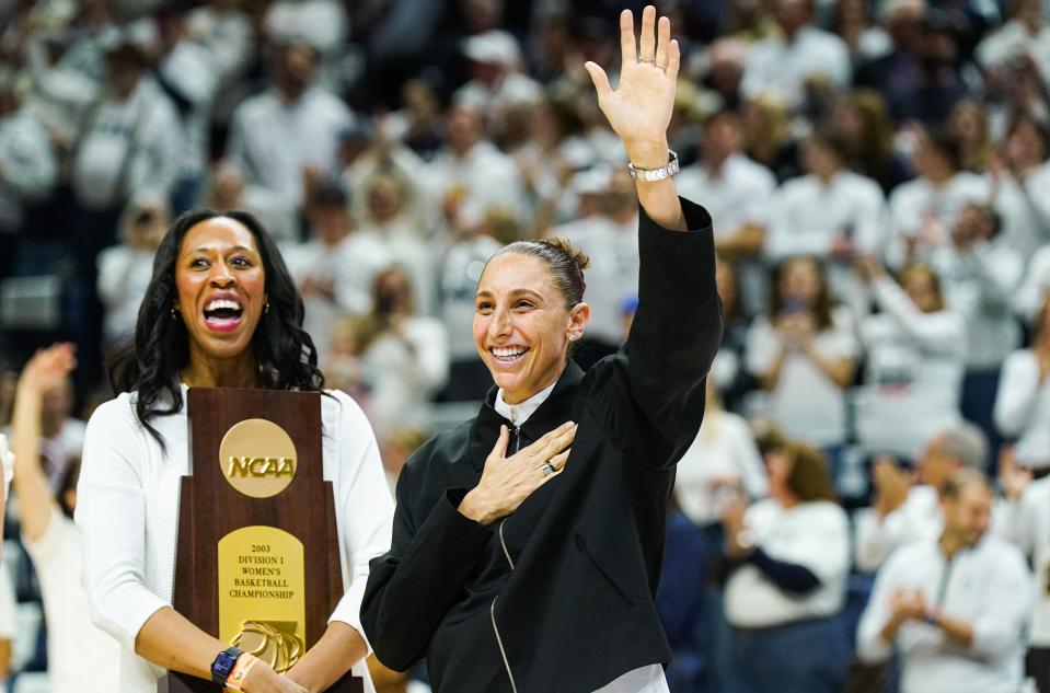 WNBA player and former UConn Huskies player Diana Taurasi waves to the crowd as she and other players are recognized for their championship wins at UConn before a game on Jan. 27, 2024. Taurasi was part of the 2002 team that went 39-0.