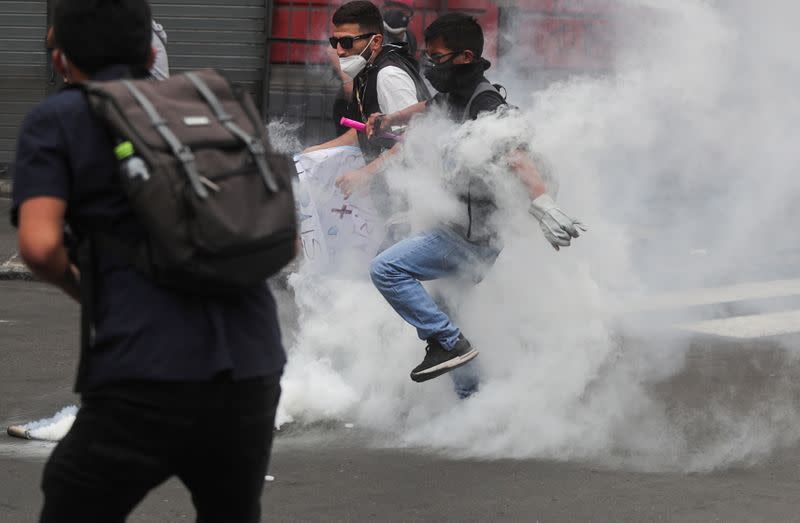 Demonstrators clash with police during protests after Peru's interim President Manuel Merino was sworn in following the removal of President Martin Vizcarra, in Lima