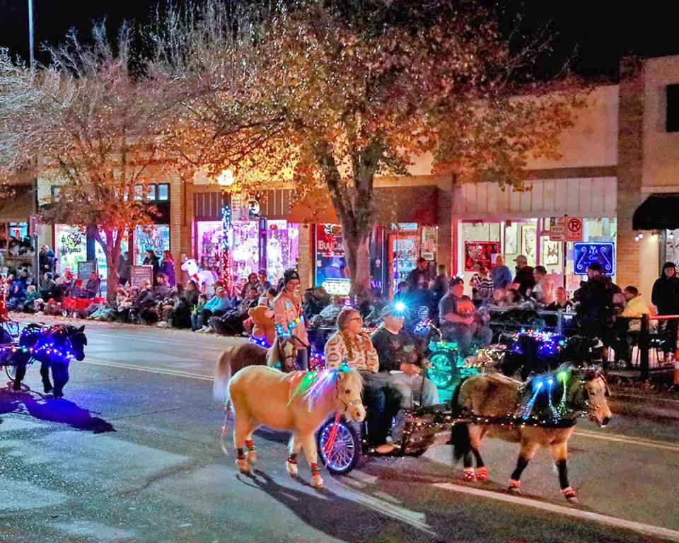 Adorable miniature horses and their owners participate in last year's Parade of Lights in downtown Pueblo.