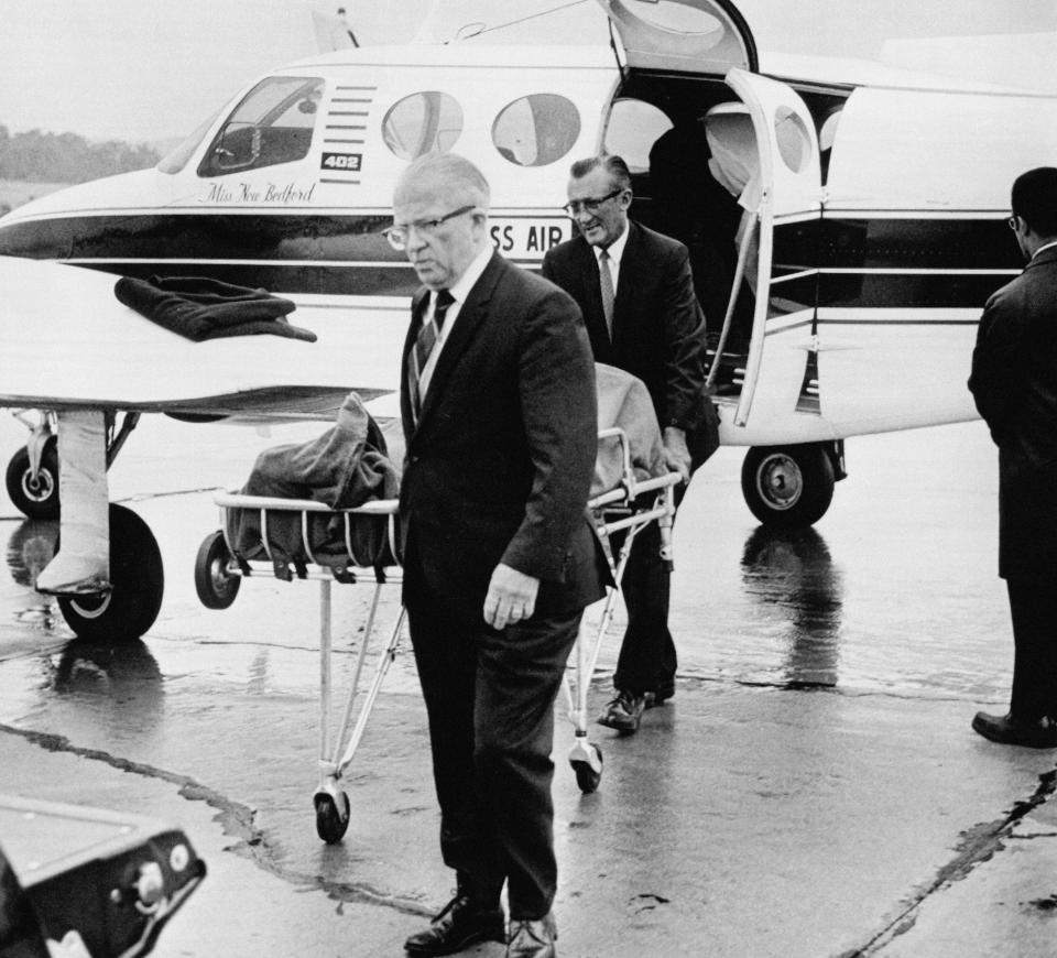 FILE - In this July 20, 1969 file photograph, undertakers wheel the body of Mary Jo Kopechne, 29, to a waiting hearse at the Scranton-Wilkes Barre airport in Scranton, Pennsylvania. Kopechne drowned after a car driven by U.S. Sen. Edward Kennedy plunged off a bridge on Martha's Vineyard. It's been 50 years since the fateful automobile accident that killed a woman and thwarted Kennedy's presidential aspirations. (AP Photo, File)