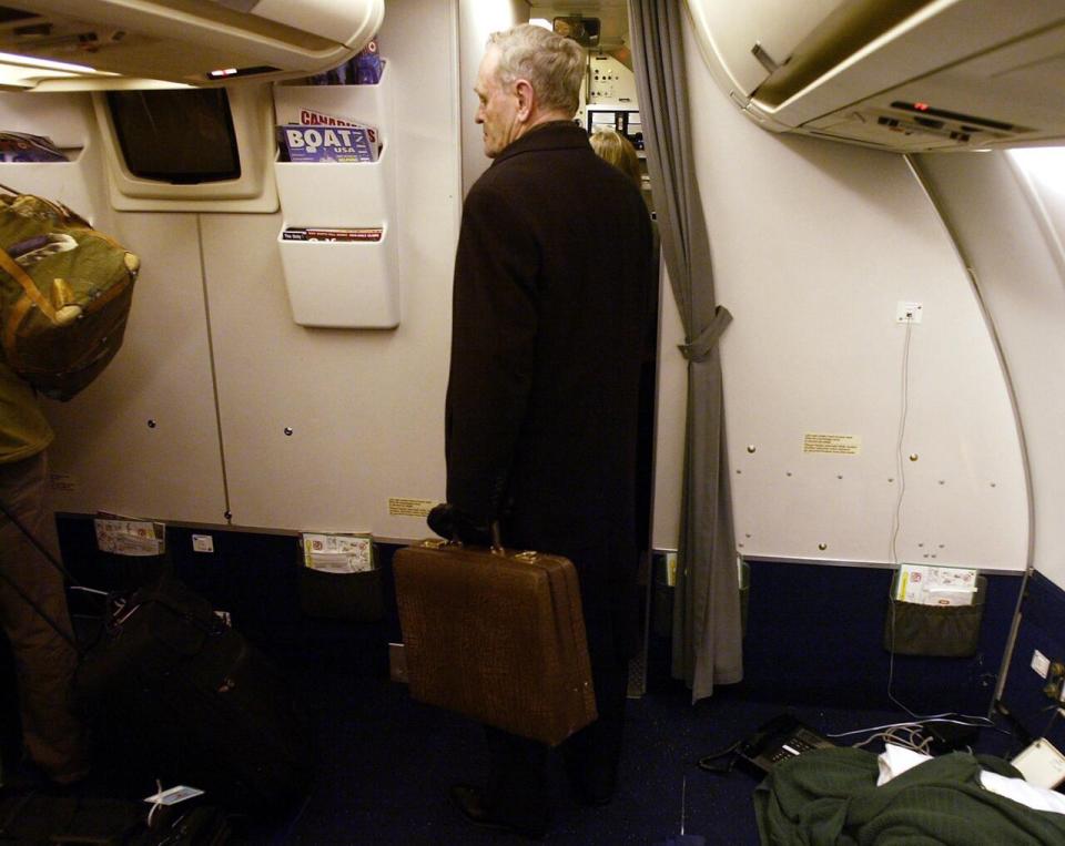 Prime Minister Jean Chretien stands with his briefcase before exiting the plane following his last foreign trip as leader of the country, Wednesday Dec 10, 2003 in Ottawa Ontario, Canada.
