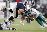 Rob Gronkowski #87 of the New England Patriots is hit by Yeremiah Bell #37 of the Miami Dolphins during the second half of New England's 27-24 win at Gillette Stadium on December 24, 2011 in Foxboro, Massachusetts. (Photo by Winslow Townson/Getty Images)