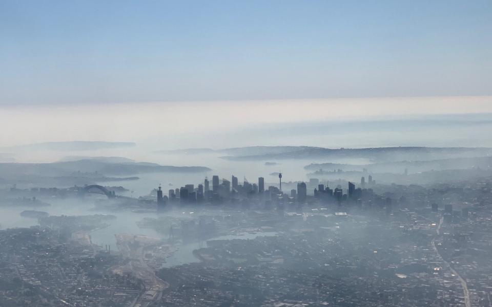 An image taken on a smart phone from a plane window shows smoke haze blanketing Sydney - REUTERS