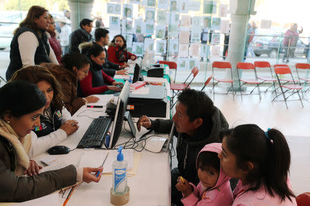 Residents provide information to government employees about their relatives missing after an explosion of a fuel pipeline ruptured by suspected oil thieves, in the municipality of Tlahuelilpan, state of Hidalgo, Mexico January 22, 2019. Picture taken January 22, 2019. REUTERS/Mohammed Salem